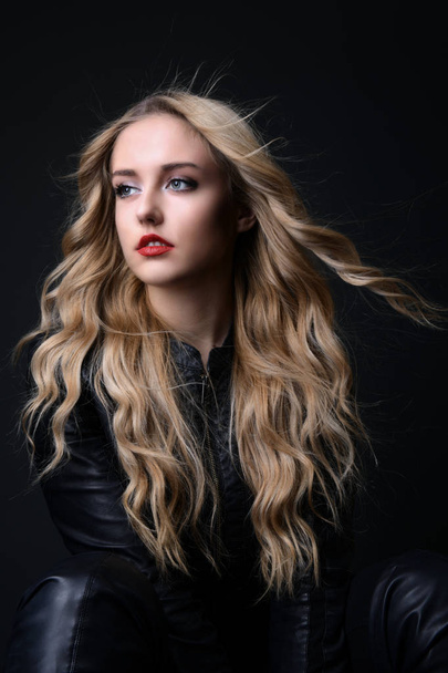 Blonde girl with long and volume shiny wavy hair . Beautiful woman model with curly hairstyle . - 写真・画像