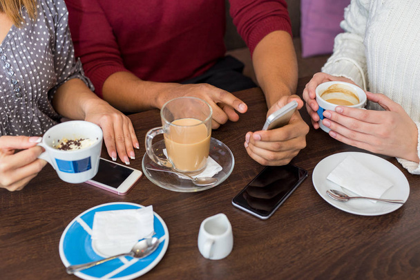 Closeup of friends having coffee at a cafe - Fotoğraf, Görsel