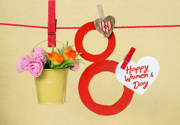 С Днем Женщин. празднование 8 марта, леденец форме фигуры восемь 8, примечание к тексту, цветы в цветных ведрах
  - Фото, изображение