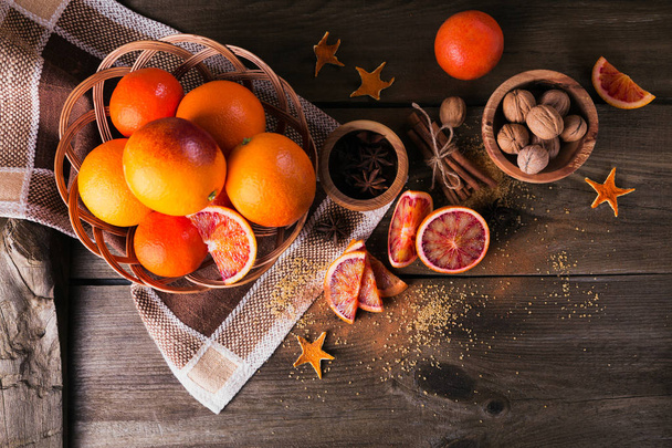 Fresh red orange fruit, anise, cinnamon and walnuts - Фото, изображение