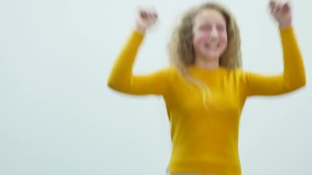 girl jumps, emotions of happiness and fun. white background. slow motion - Felvétel, videó