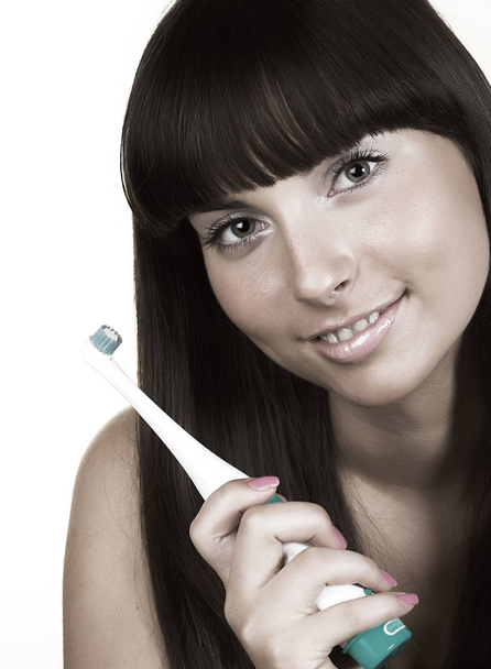 Young beautiful smiling woman with great white teeth holding a t - Foto, Imagen
