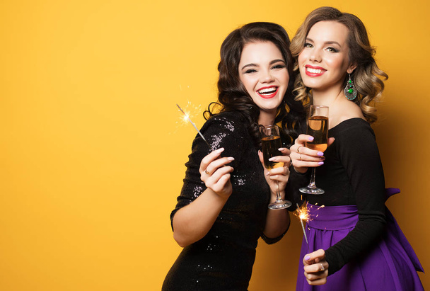 Two beautiful elegant women celebrate party and drinking champagne. - Valokuva, kuva
