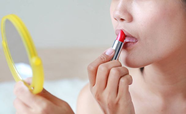 Portrait of beautiful woman applying lipstick. Beauty Concept. - Φωτογραφία, εικόνα