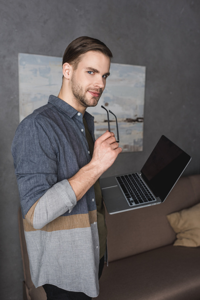 young stylish businessman with laptop at modern office - Photo, Image
