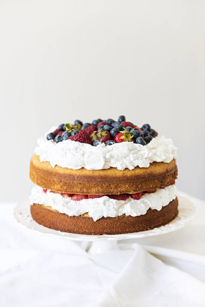 Beautiful, fruit naked cake over a white wall - Fotoğraf, Görsel