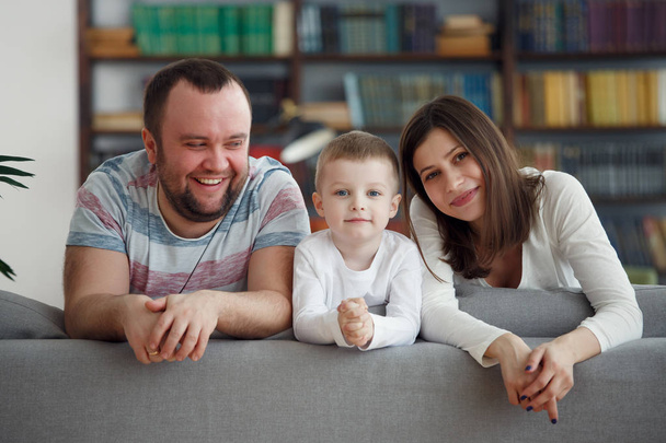 Foto de padres felices con niños en sofá gris
 - Foto, Imagen