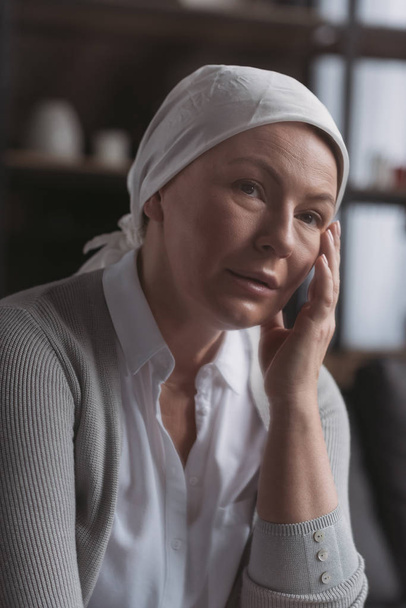 portrait of sick mature woman in kerchief looking at camera - Фото, зображення