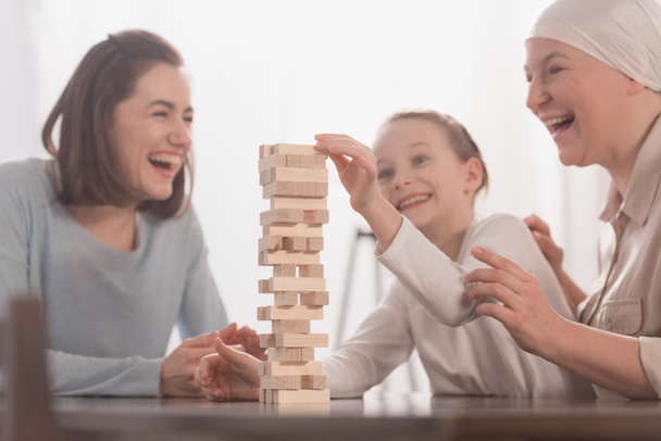 happy family playing with wooden blocks together, cancer concept - Photo, image