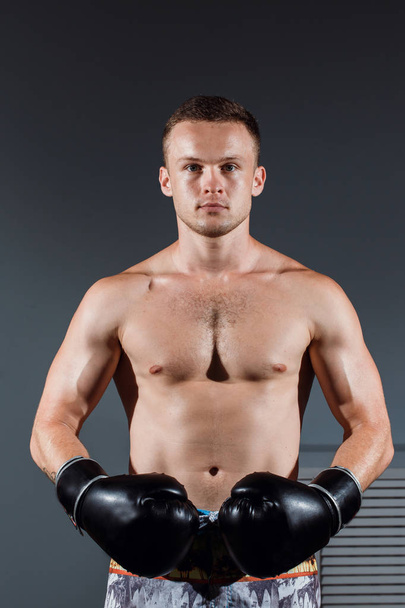 handsome man or healthy boxer or Thai boxer with six pack wearing boxing gloves - Fotoğraf, Görsel