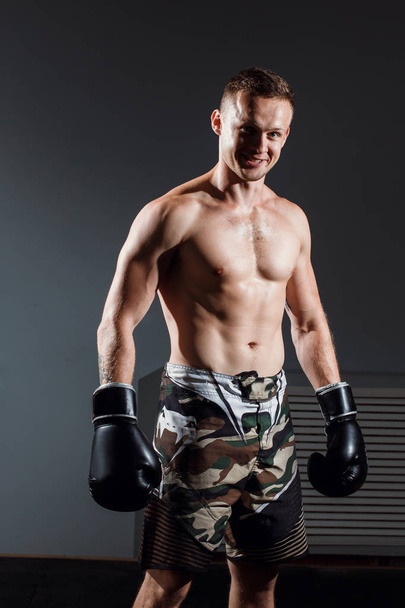 handsome man or healthy boxer or Thai boxer with six pack wearing boxing gloves - Fotografie, Obrázek
