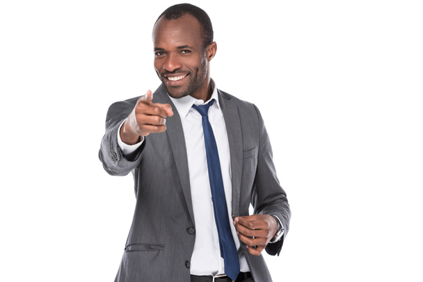 portrait of smiling african american businessman pointing at camera isolated on white - Fotografie, Obrázek