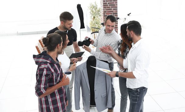 group of designers discussing new models of mens clothing. - Foto, afbeelding