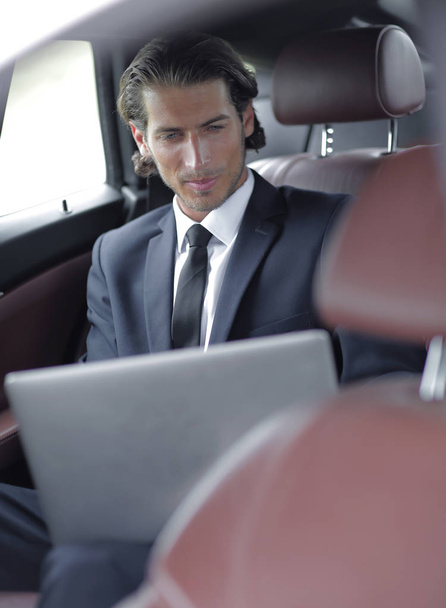 man working on laptop while sitting in the car - Photo, Image