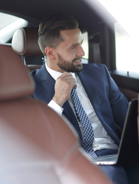 Close-up of a successful businessman sitting in a comfortable car - Photo, image