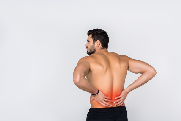 back view of young shirtless man with back pain isolated on white - Photo, Image