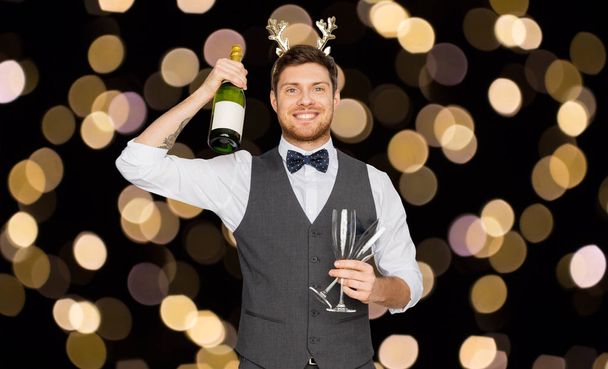 man with bottle of champagne at christmas party - Foto, immagini