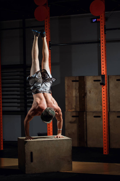Handstand on box push-up man workout at gym push ups - 写真・画像