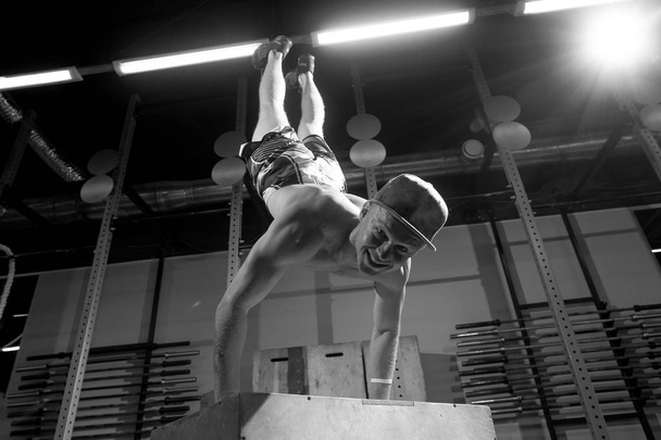 Handstand on box push-up man workout at gym push ups - Фото, изображение