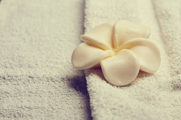 flor blanca sobre toalla
 - Foto, Imagen