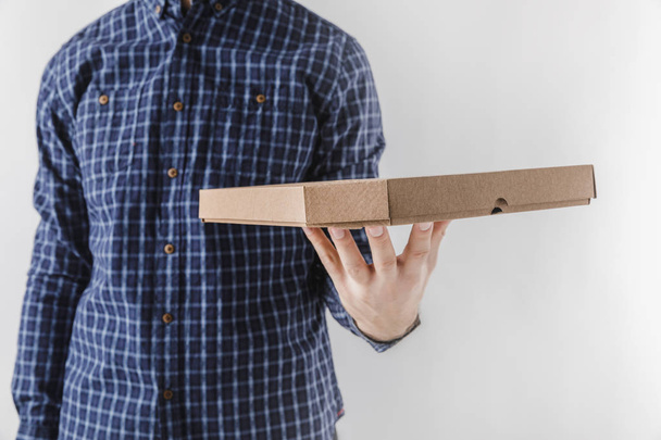 cropped image of courier holding pizza box isolated on white - Fotografie, Obrázek