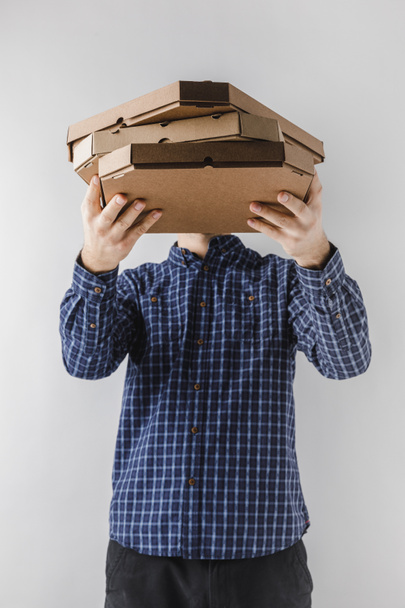 courier holding pizza boxes isolated on white - Φωτογραφία, εικόνα