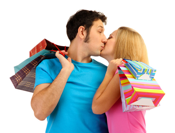 Young couple shopping and holding many shopping bags isolated on white - Foto, Imagen
