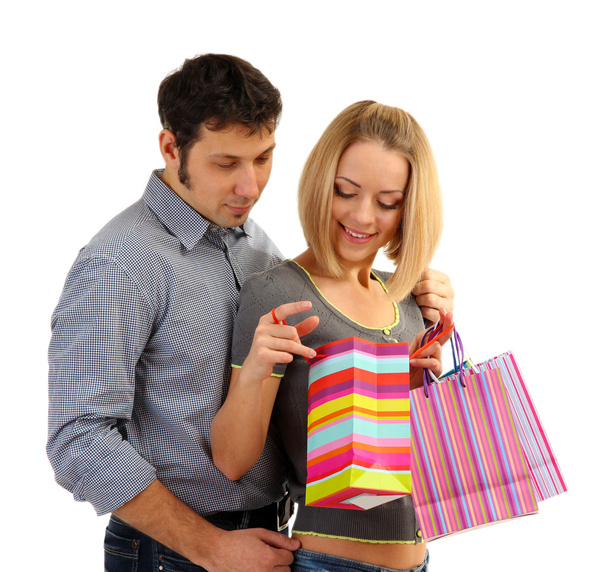 junges Paar beim Einkaufen und hält viele Einkaufstüten isoliert auf weiß - Foto, Bild