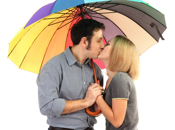 Loving couple with umbrella isolated on white - Фото, изображение