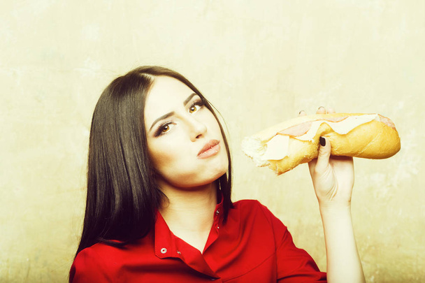 sexy pretty brunette woman eats big sandwich or burger - Photo, Image