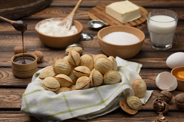 homemade cookies shaped nuts with cream boiled condensed milk on wooden table - Photo, Image