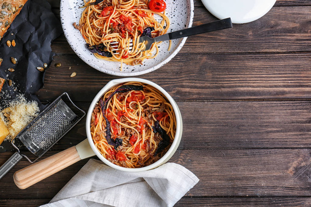 Delicious pasta Bolognaise in pan on table - Fotó, kép