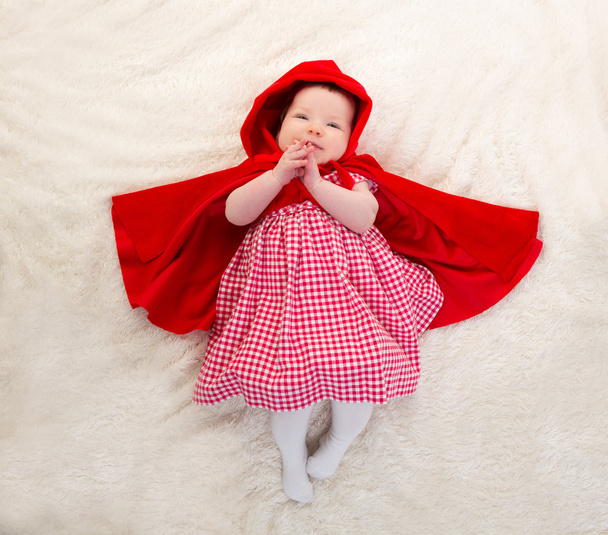 Baby Little Red Riding Hood on white fur - 写真・画像