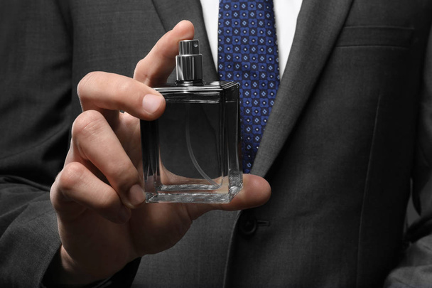  man with bottle of perfume  - Фото, изображение