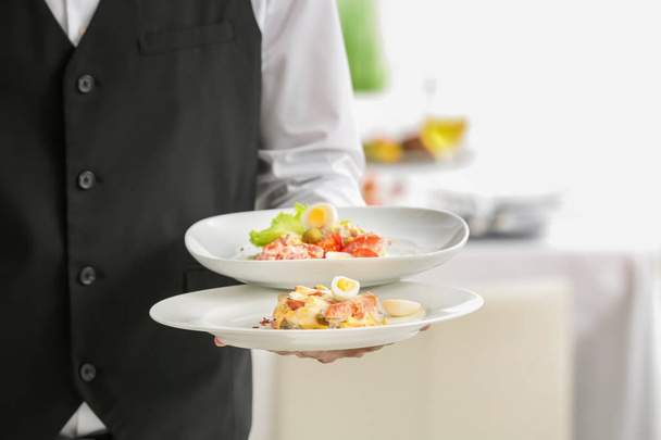 Waiter holding plates with dishes  - Zdjęcie, obraz