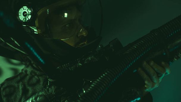 Soldier, cyborg man of the future with helmet lights led and huge laser gun - Фото, зображення