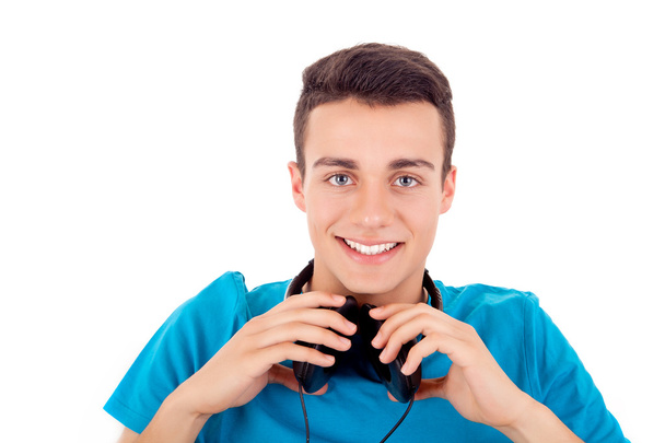 Beautiful young man listening to music on his headphones - Foto, imagen