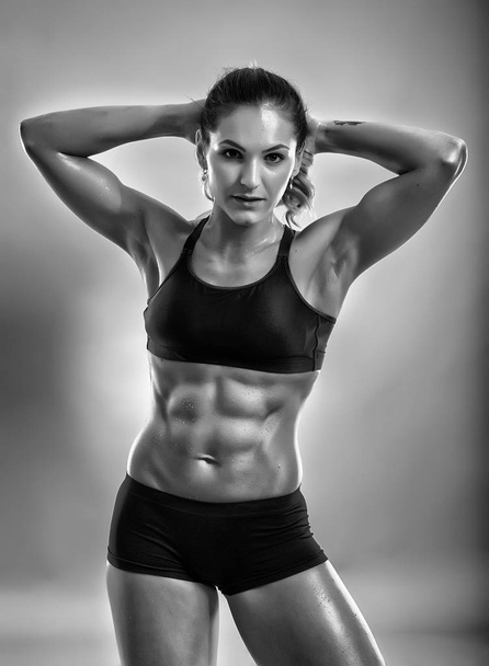 Muscular female fitness model posing in sport bra and boxers - Zdjęcie, obraz