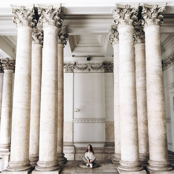 view of young woman near ancient building with columns - Foto, immagini