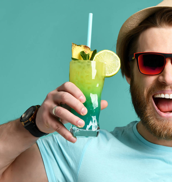 Young man in hat and red sunglasses hold cocktail drink juice happy screaming   - Фото, зображення