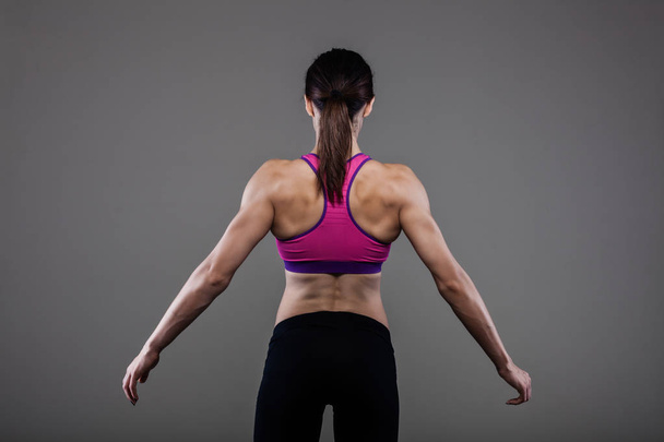 muscular back of a fitness girl - Фото, изображение