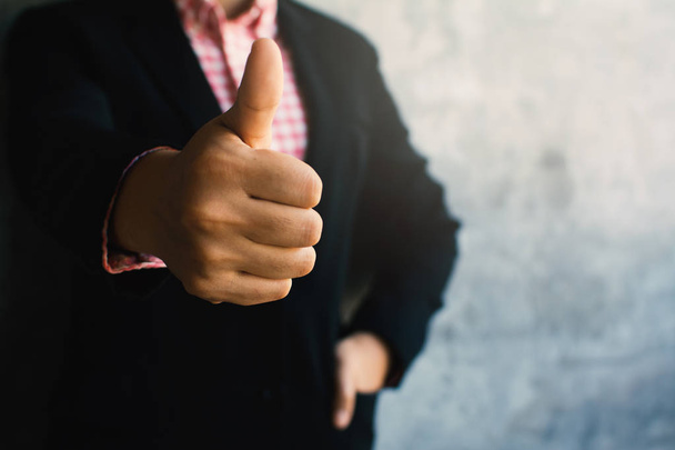 Close up of hand businesswoman thumbs up with confidence on loft background - Foto, imagen