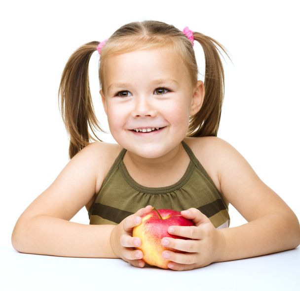 Little girl with red apple - Фото, зображення