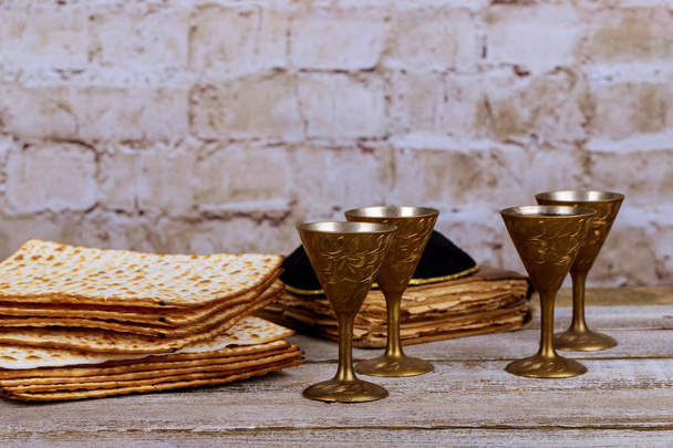 Symbols of Passover background. wine and matzoh jewish holiday bread over wooden board. - Photo, Image