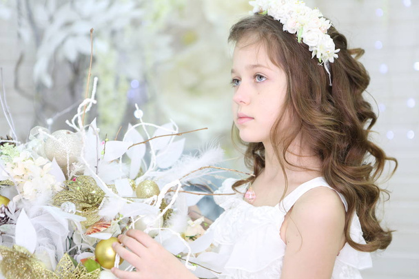 Beautiful girl in white dress and wreath - Foto, afbeelding