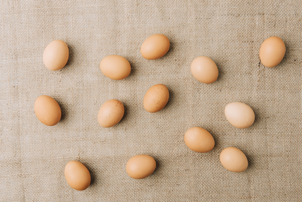brown eggs scatterd on sackcloth - Fotografie, Obrázek