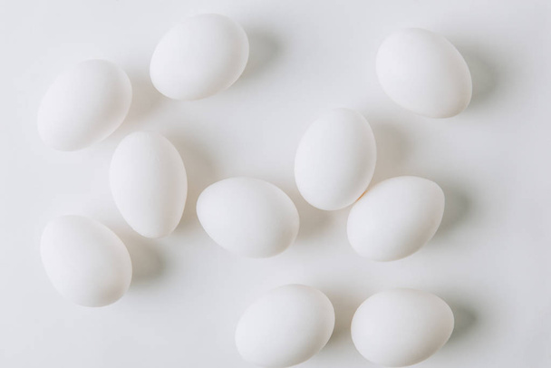 white eggs scattered on white background - 写真・画像