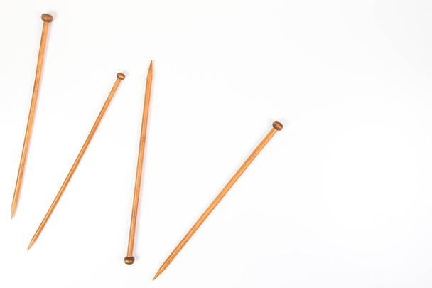 Wooden knitting needles on white background as frame - Photo, Image