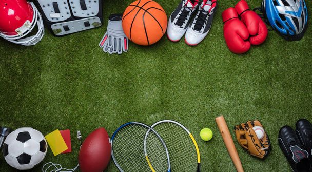High Angle View Of Various Sport Equipments On Green Grass - Foto, Bild