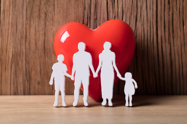 Close-up Of A Family Holding Hands Besides Red Heart Shape - Φωτογραφία, εικόνα